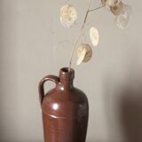 Vintage stoneware liqueur bottle with handle and spout.