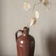 Vintage stoneware liqueur bottle with handle and spout.
