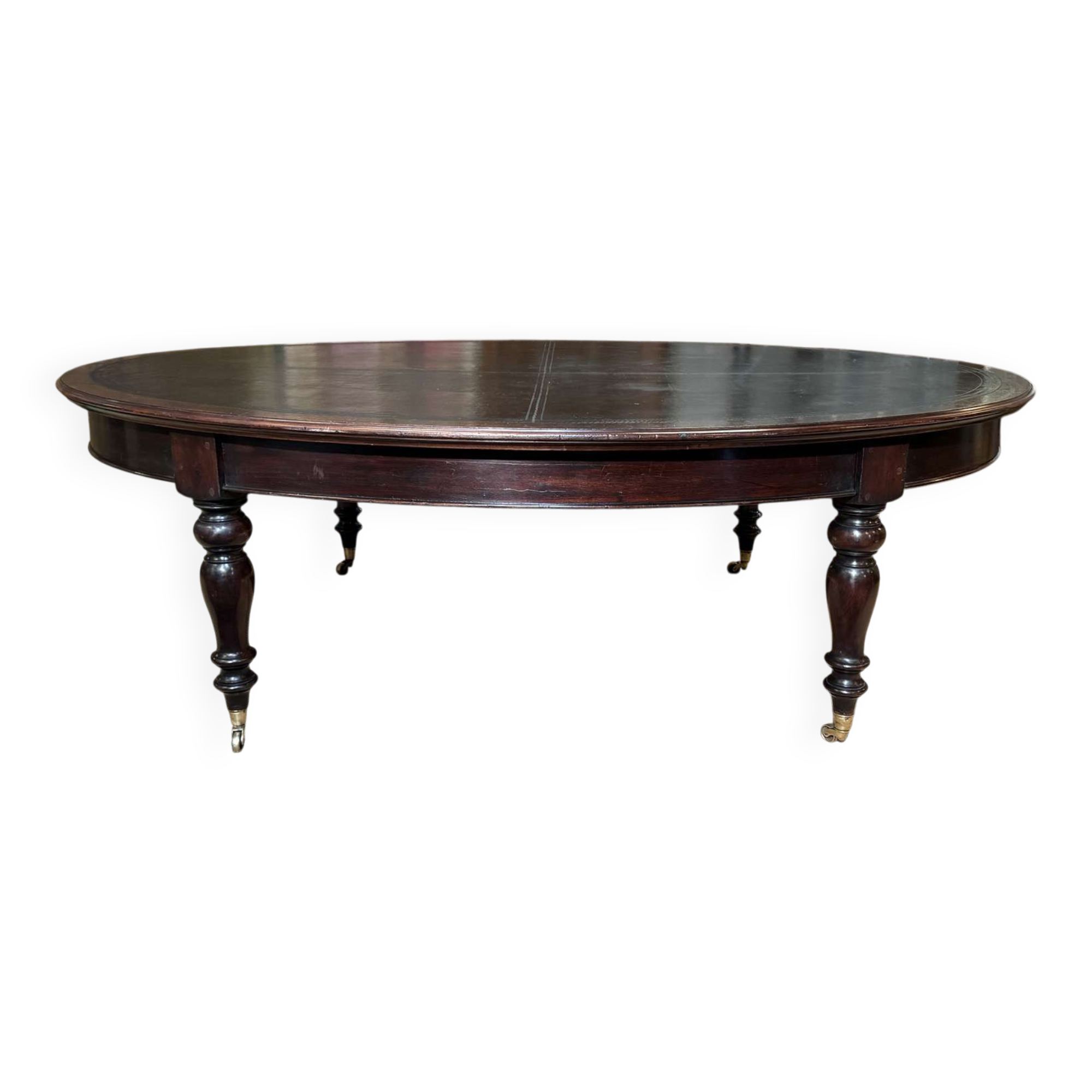 Large English library table in dark walnut with a leather top.