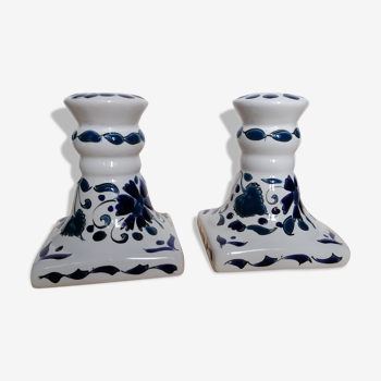 Pair of candle holders decorated in white and blue enamels