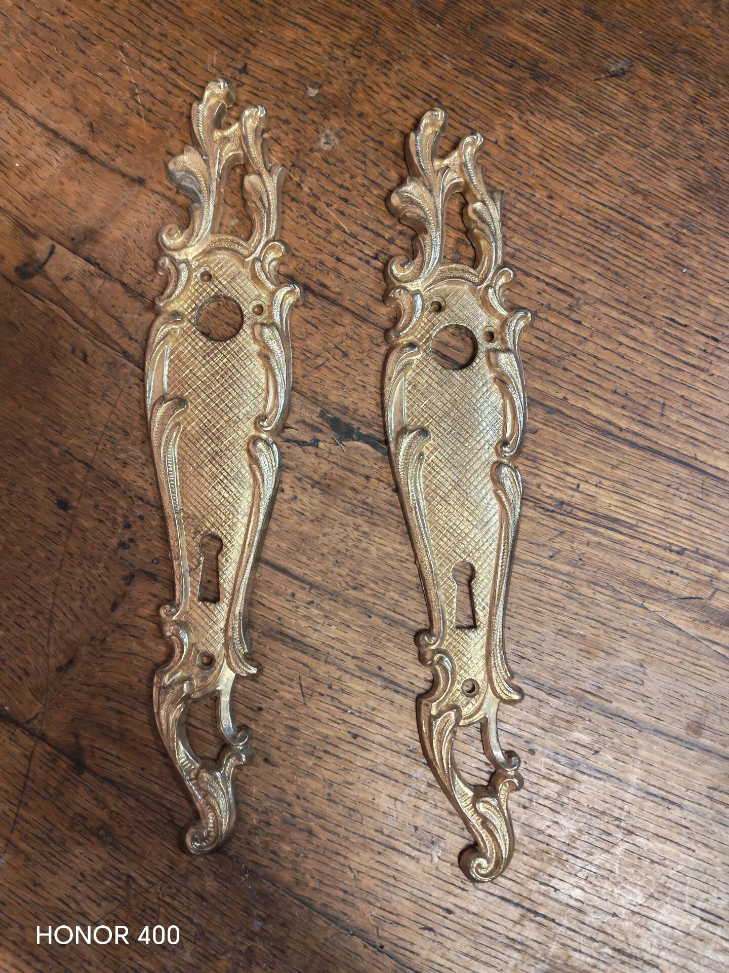 Pair of solid brass cleanliness plates in Louis XV rococo style.