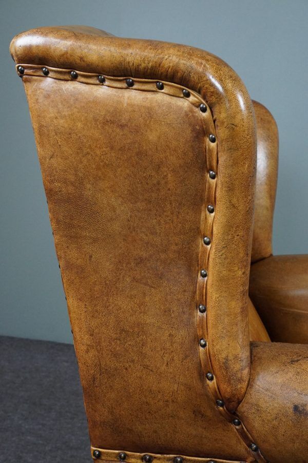Antique armchair in patinated sheepskin