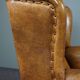 Antique armchair in patinated sheepskin