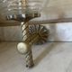 Pair of neoclassical wall sconces in twisted brass and ribbed glass.