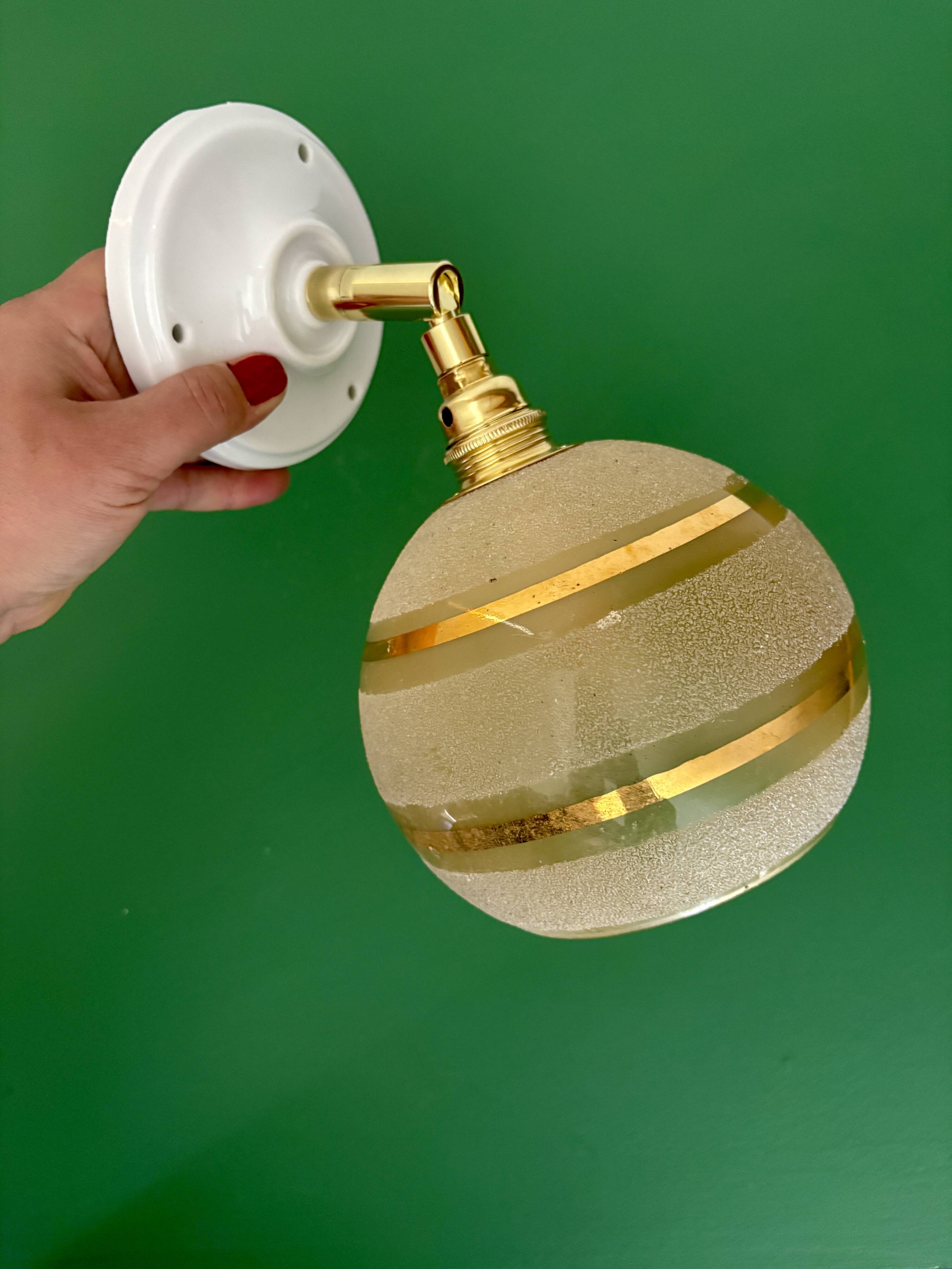 Vintage globe wall light in frosted yellow and gold glass.