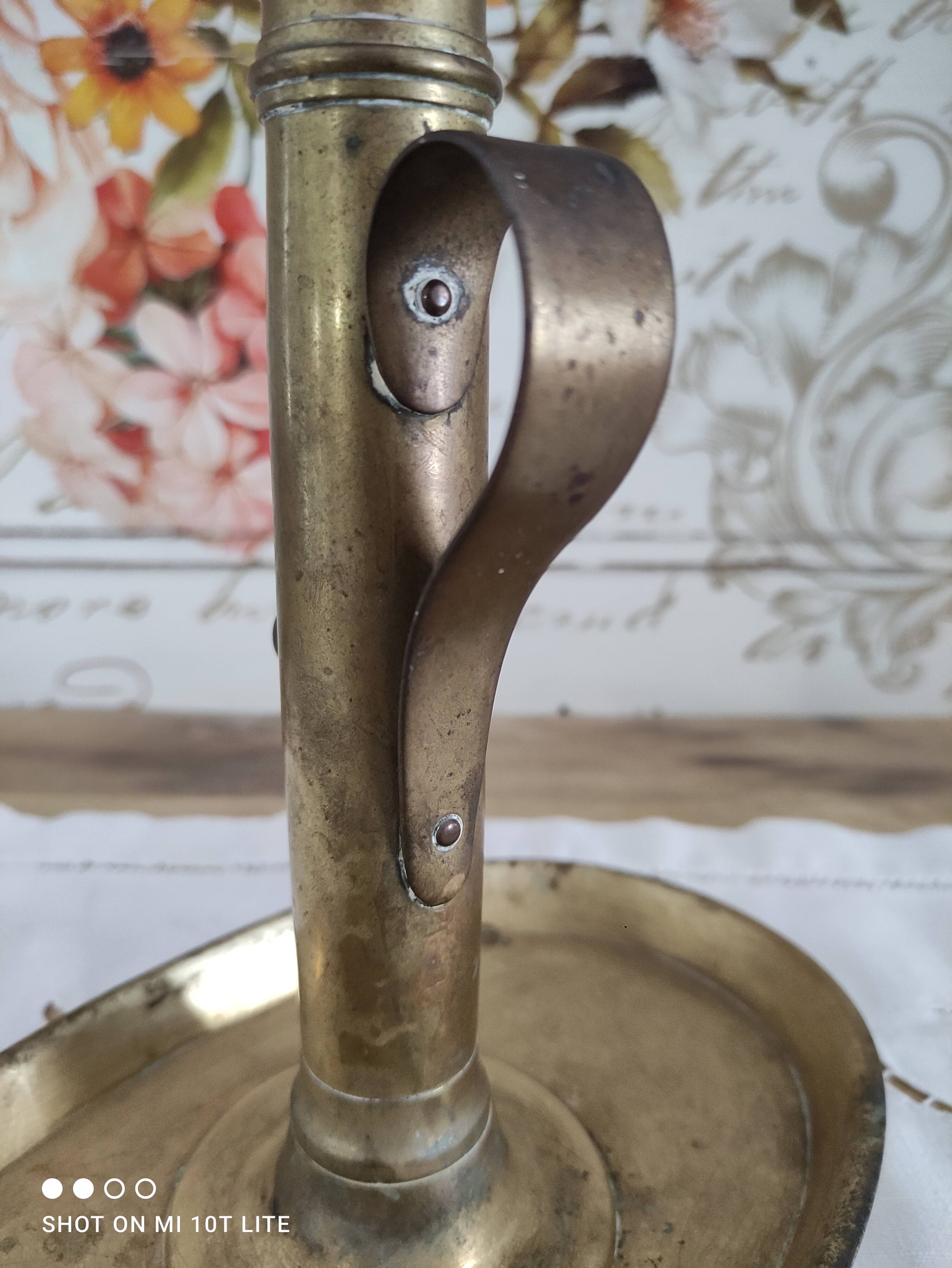 Brass pusher candle holder on oval frame
