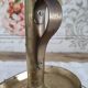Brass pusher candle holder on oval frame