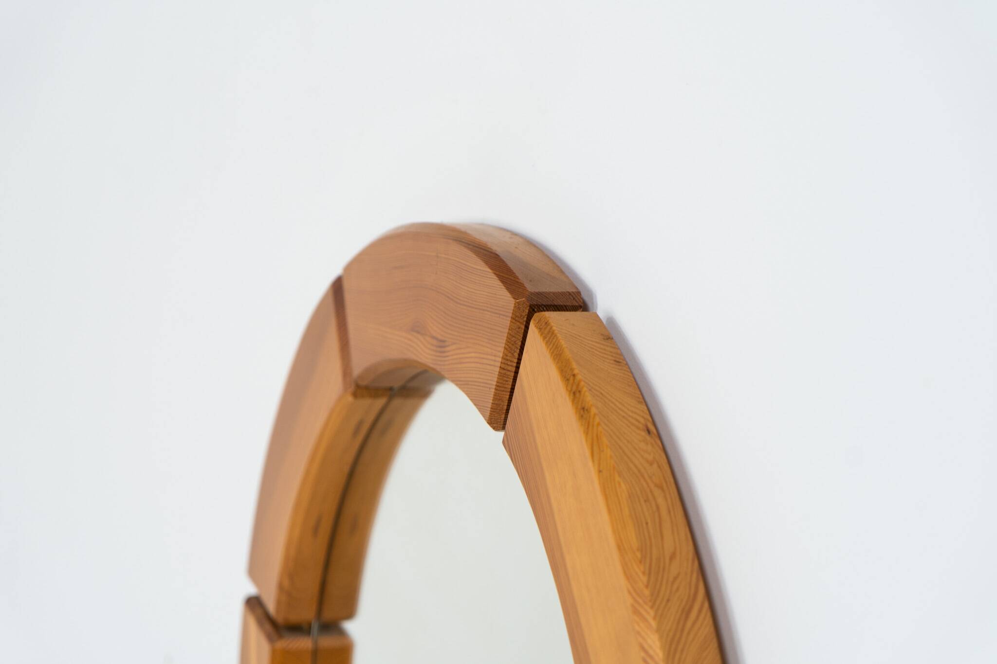 Sculptural wall mirror in solid pine