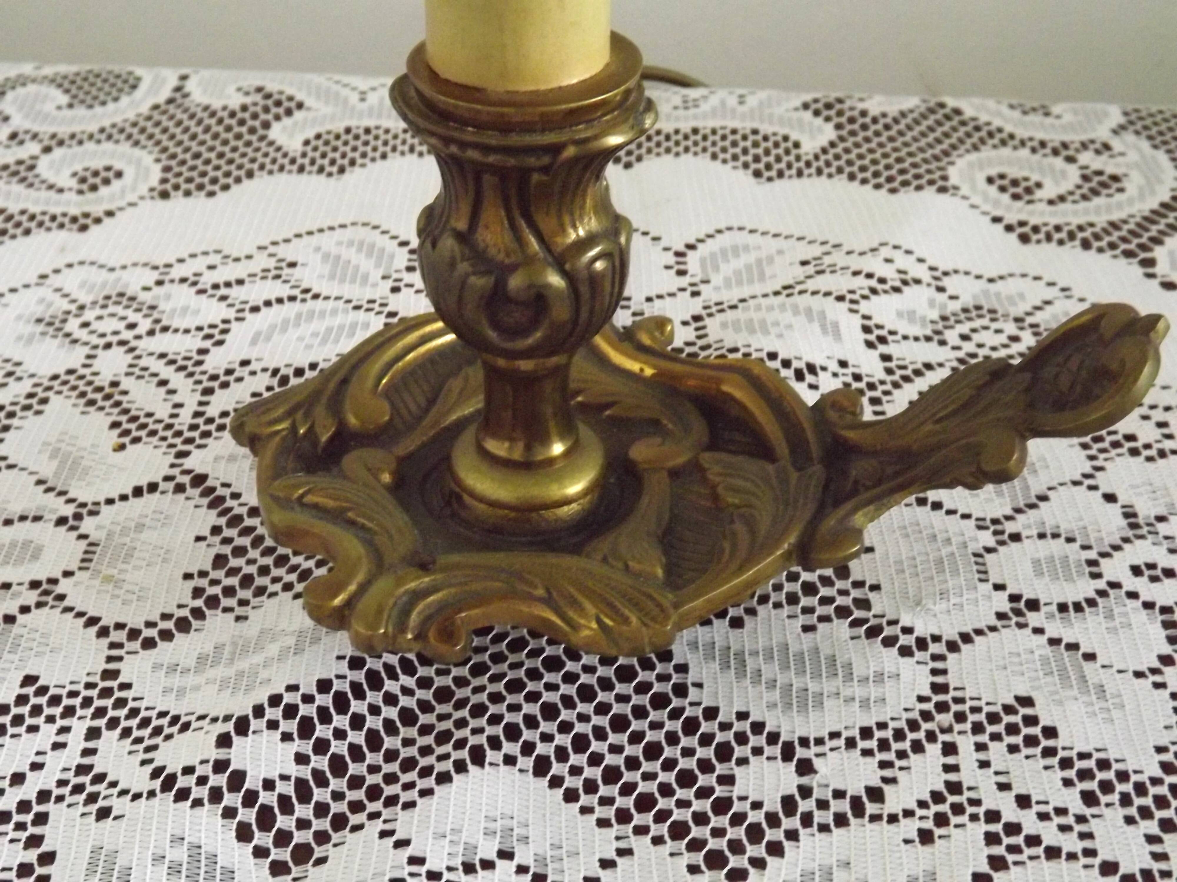 Vintage French bronze Wee Willie Winkie style lamp with red card shade.