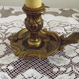 Vintage French bronze Wee Willie Winkie style lamp with red card shade.