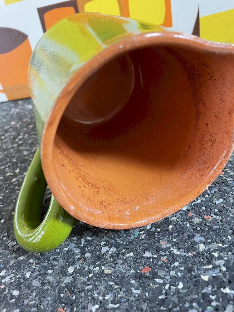 Small two-tone green glazed terracotta jug, height 12 cm.