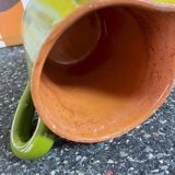 Small two-tone green glazed terracotta jug, height 12 cm.