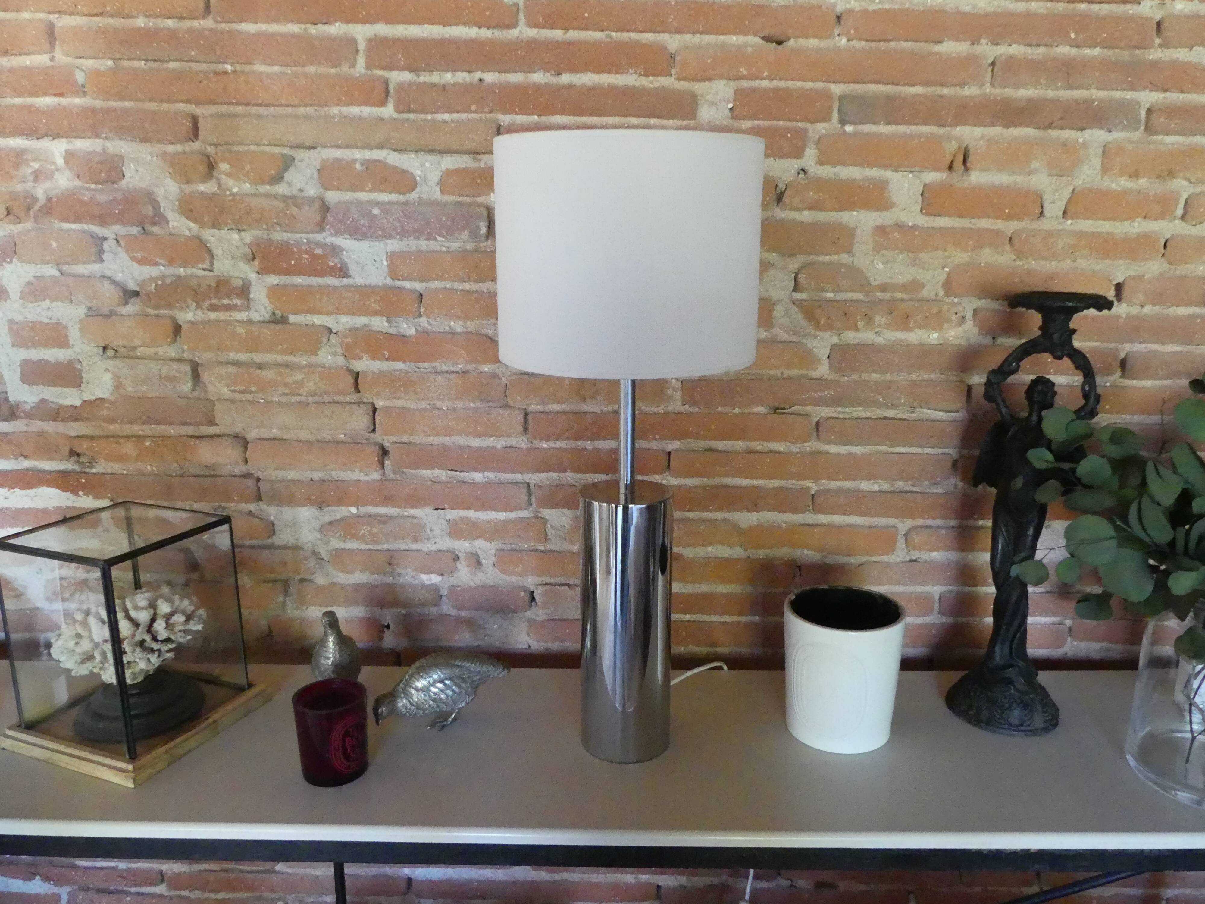 Foot of chrome lamps and ivory white lampshade