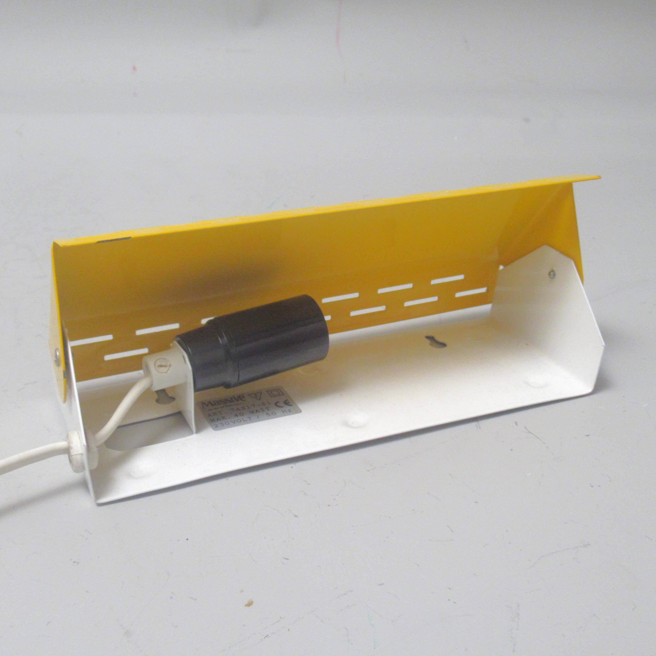 Modernist wall light with a yellow pivoting shade from the 1980s.