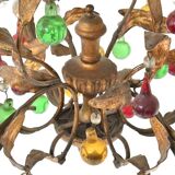 Lustrous chandelier with two wall lights decorated with foliage and pendants.