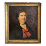 Old oil painting on canvas portrait of a woman with a red bow, late 19th century