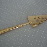 Golden metal pie shovel