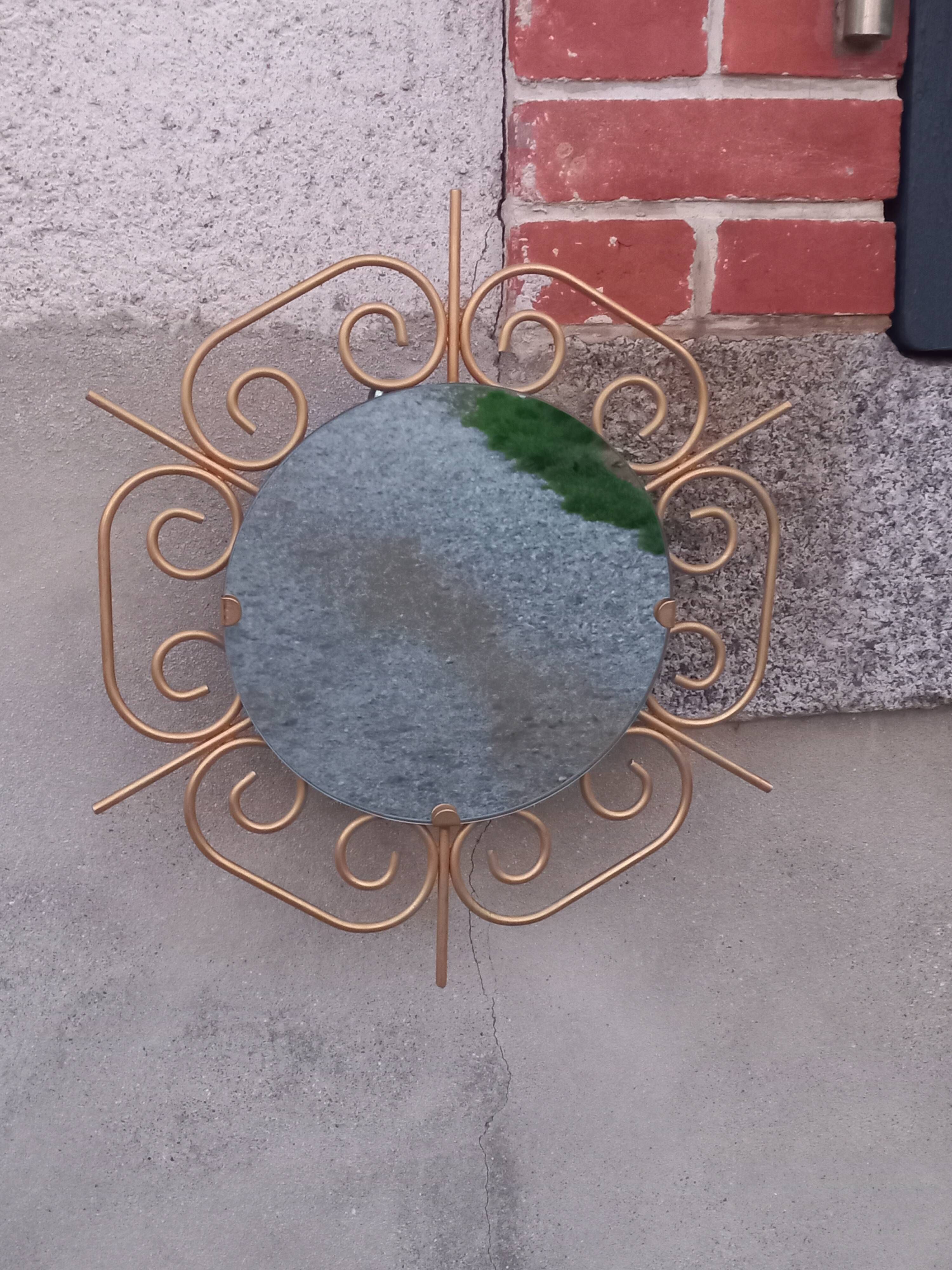 Golden metal sun mirror from the 1950s.