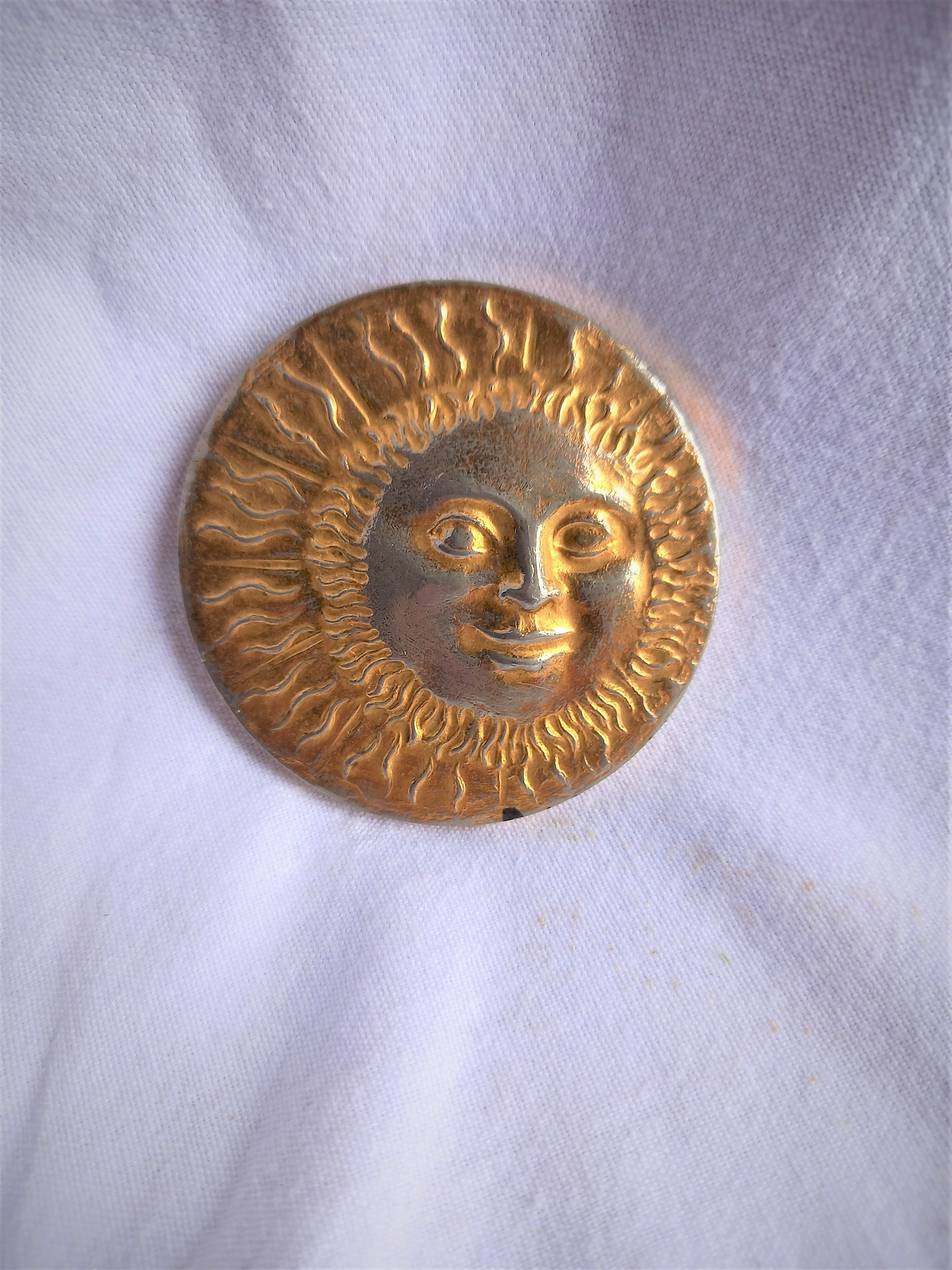 Brass sun paperweight