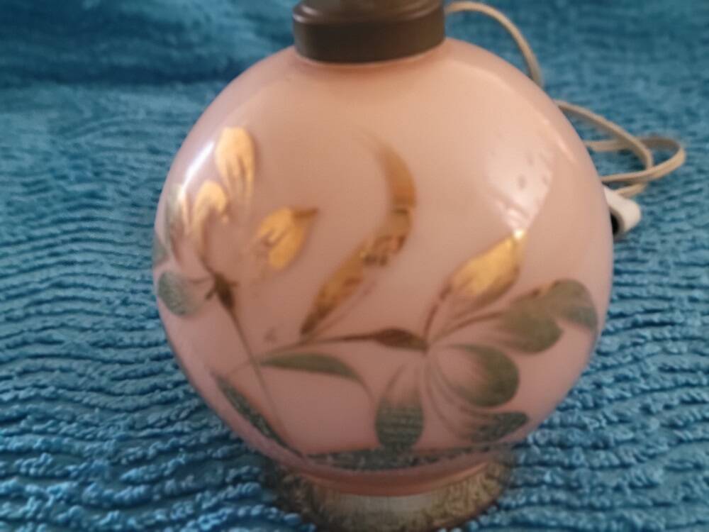 Antique lamp base with globe from the early 20th century.