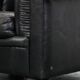 Set of a black cowhide leather Chesterfield armchair and matching ottoman