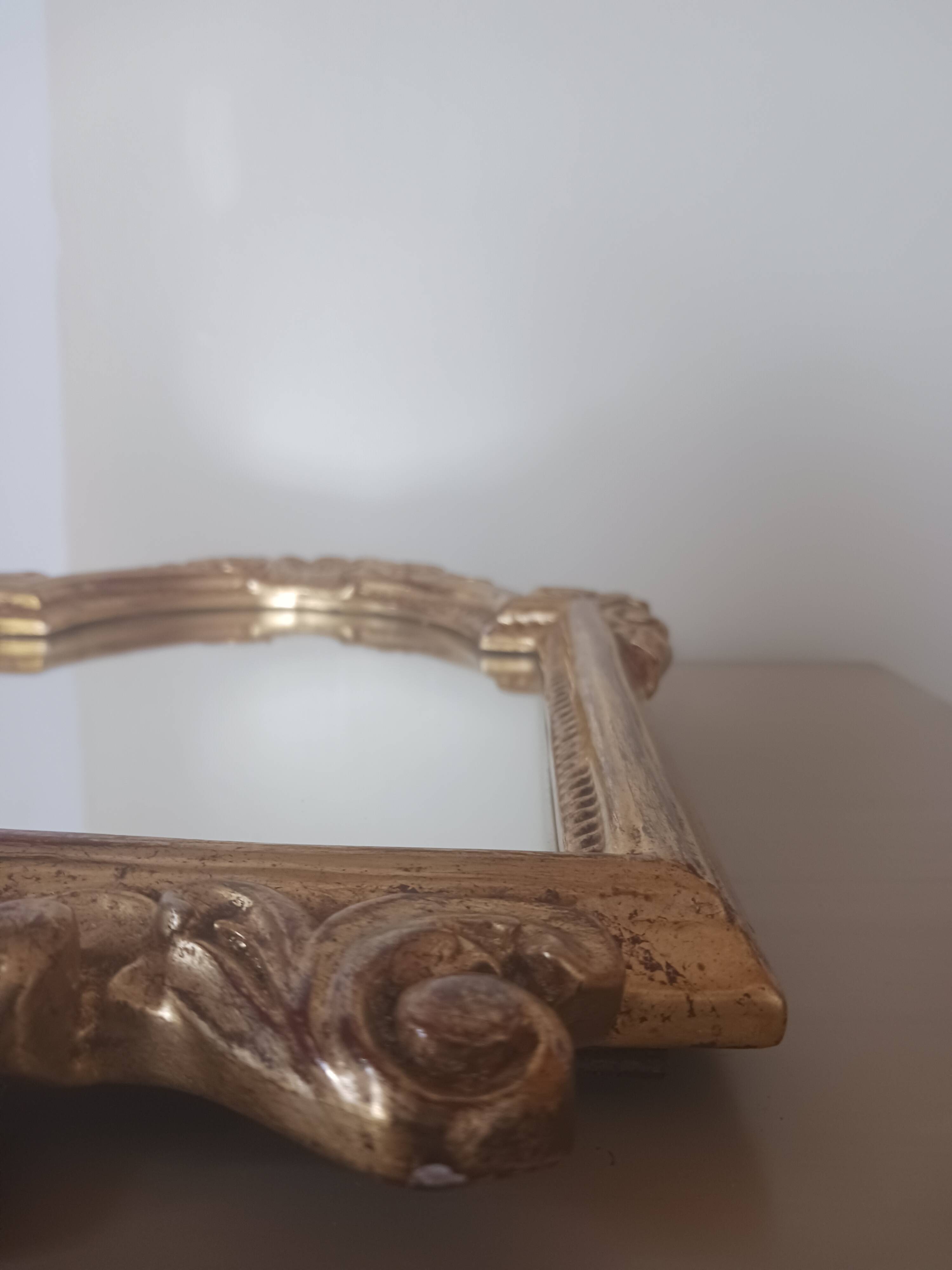 Antique mirror in gilded wood.
