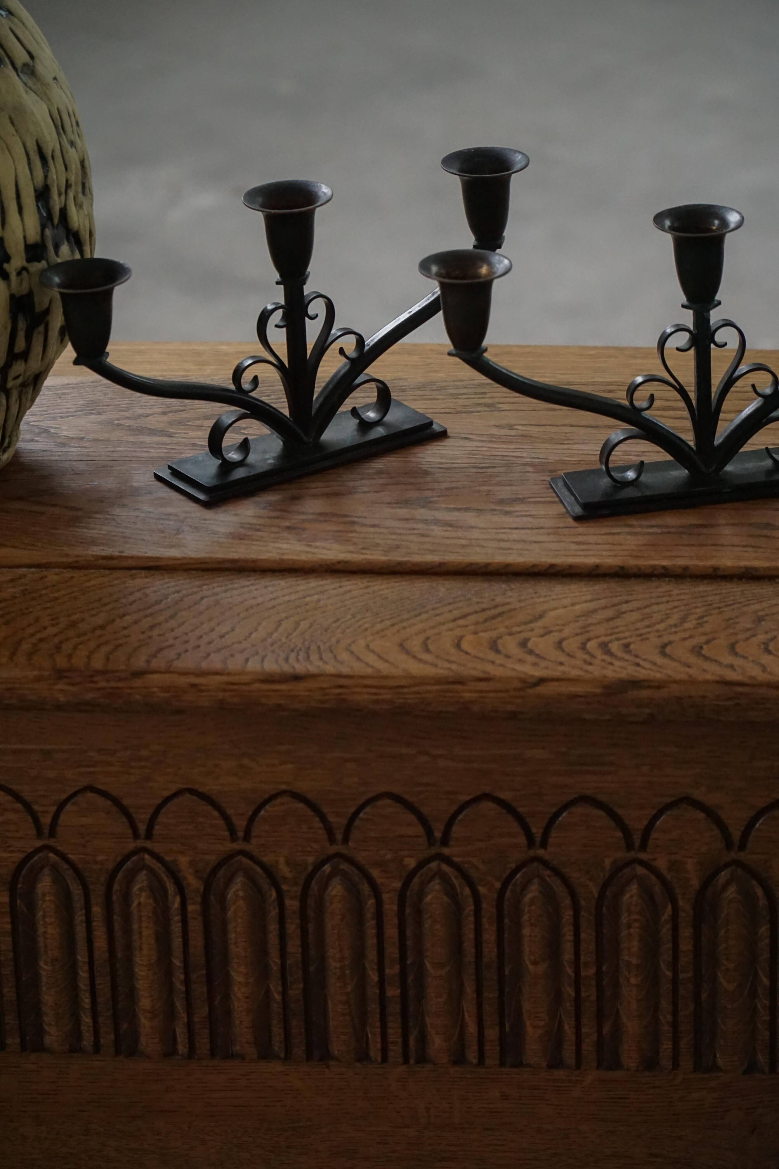 Early 20th century, pair of Danish Art Deco candlesticks in metal with three arms, 1930s.