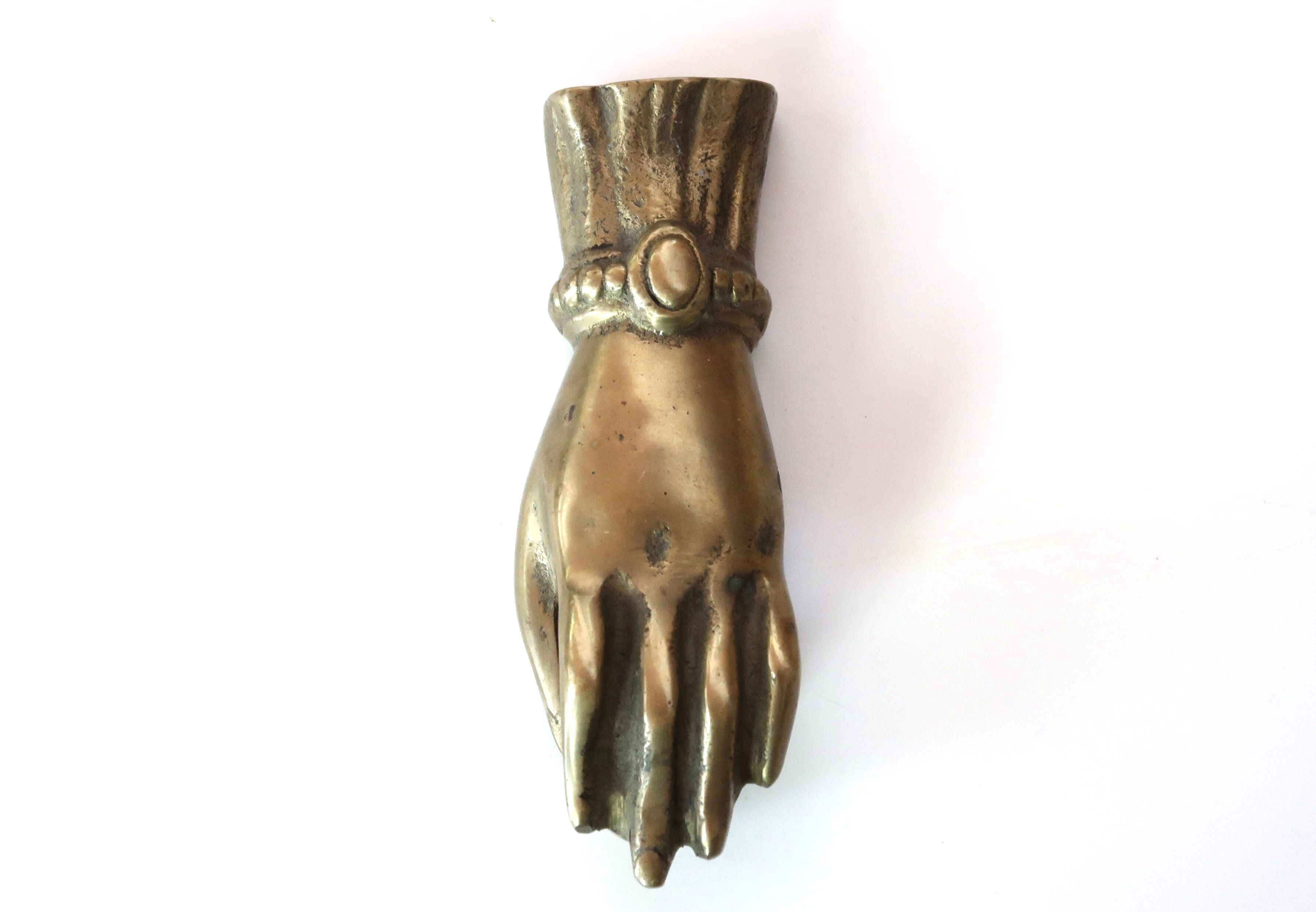 Brass hand, paper press, 50s
