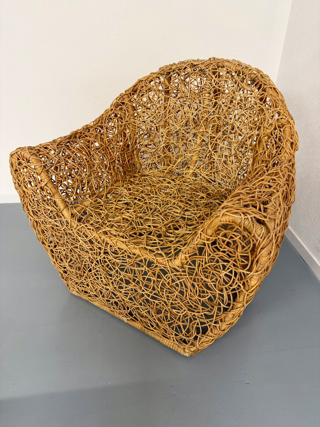 Sculptural woven rattan armchair, organic design from the 1970s.
