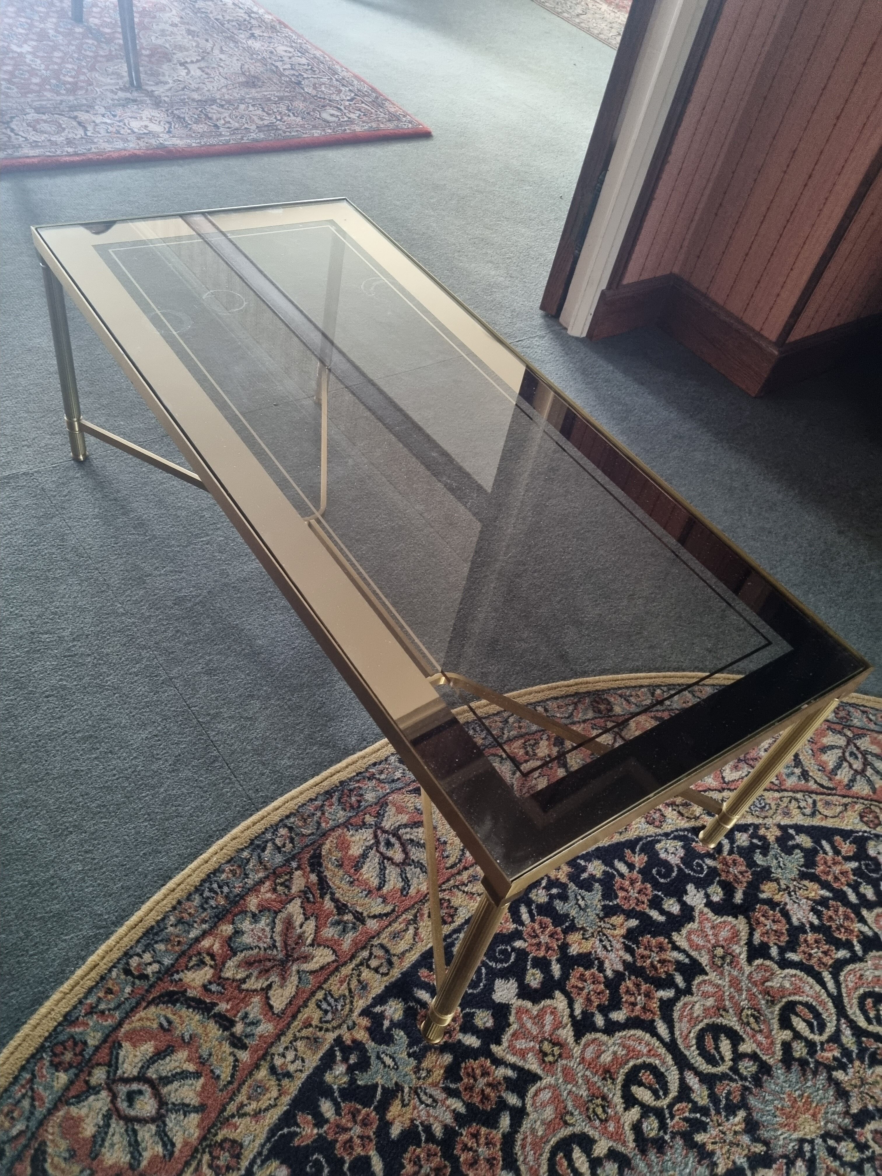 Coffee table in gilded brass and glass top