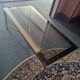 Coffee table in gilded brass and glass top