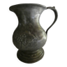 pewter pitcher with handle and bunch of grapes on the pot