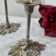 Pair of metal flower candlesticks