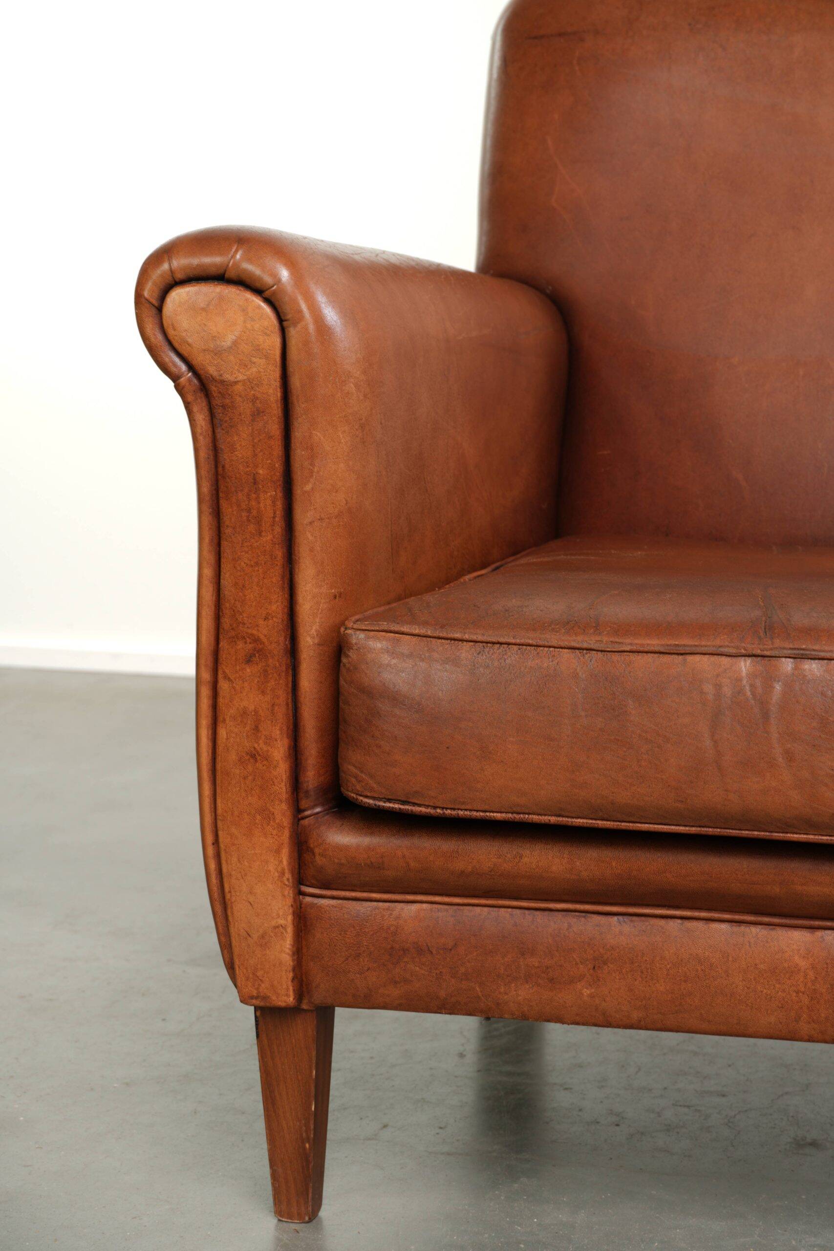 Sturdy vintage sheepskin armchair with a beautiful cognac colour
