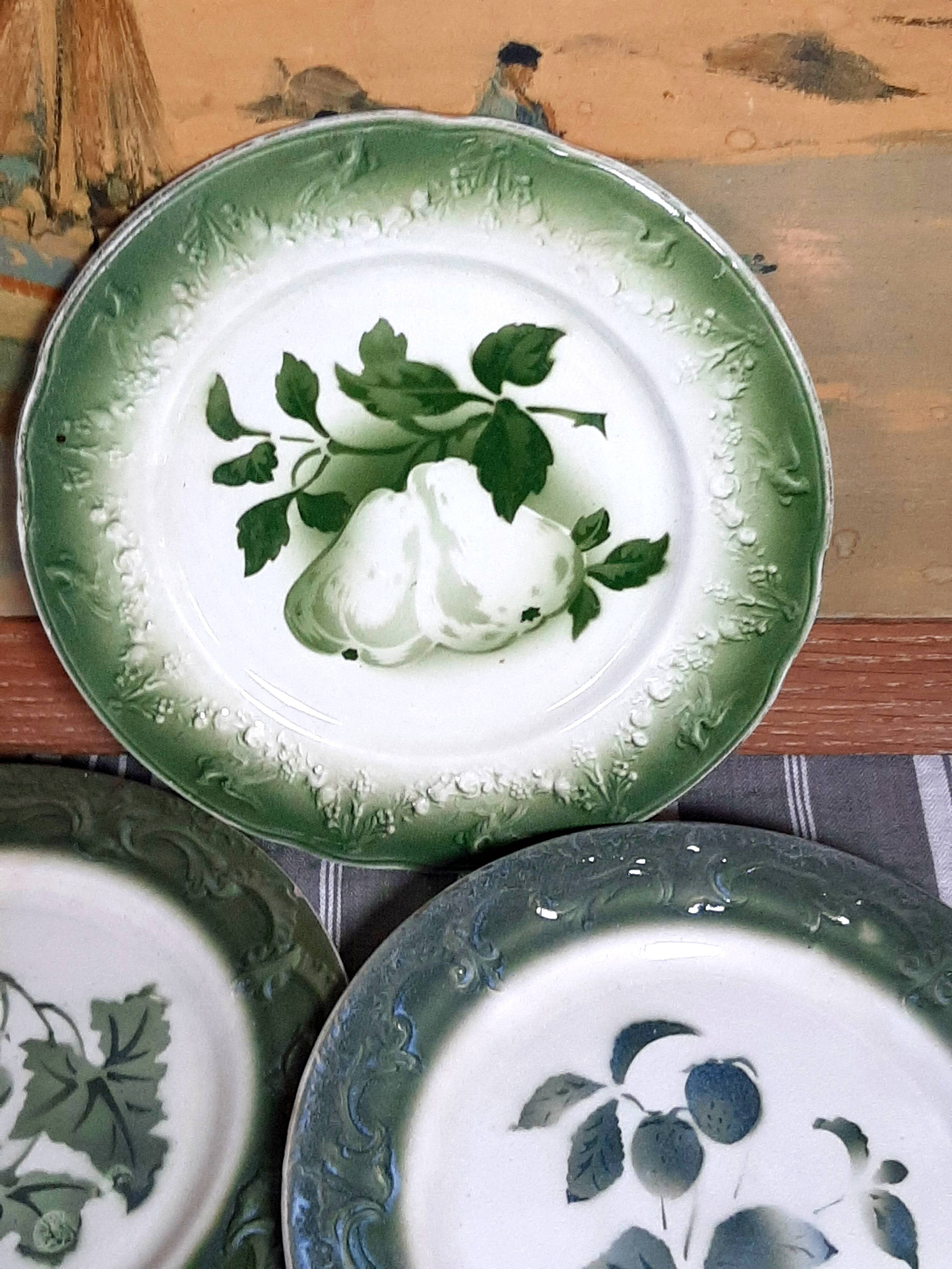 Antique earthenware plates with fruit decoration.