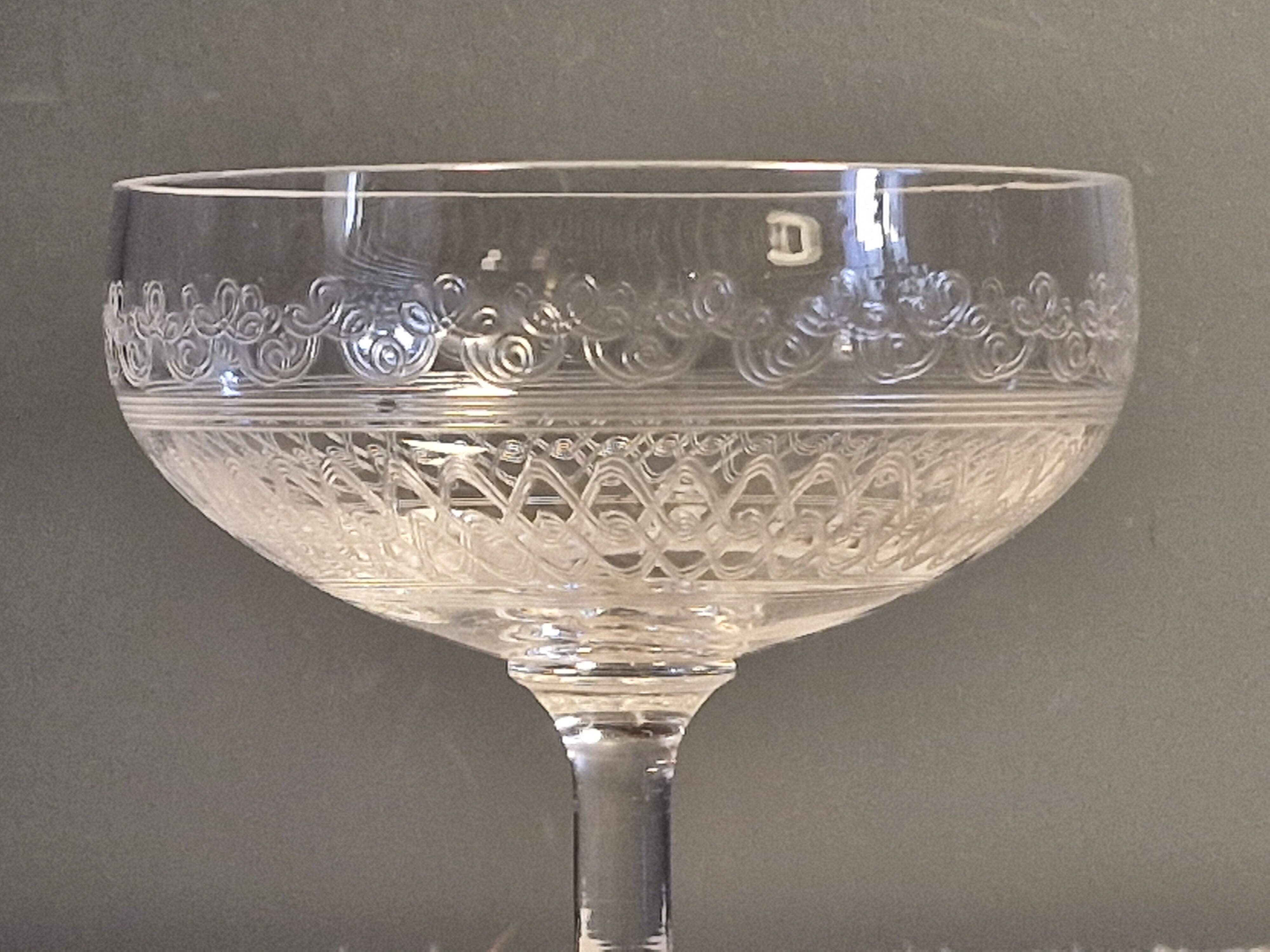 8 antique Baccarat crystal champagne coupes with engraved decoration.