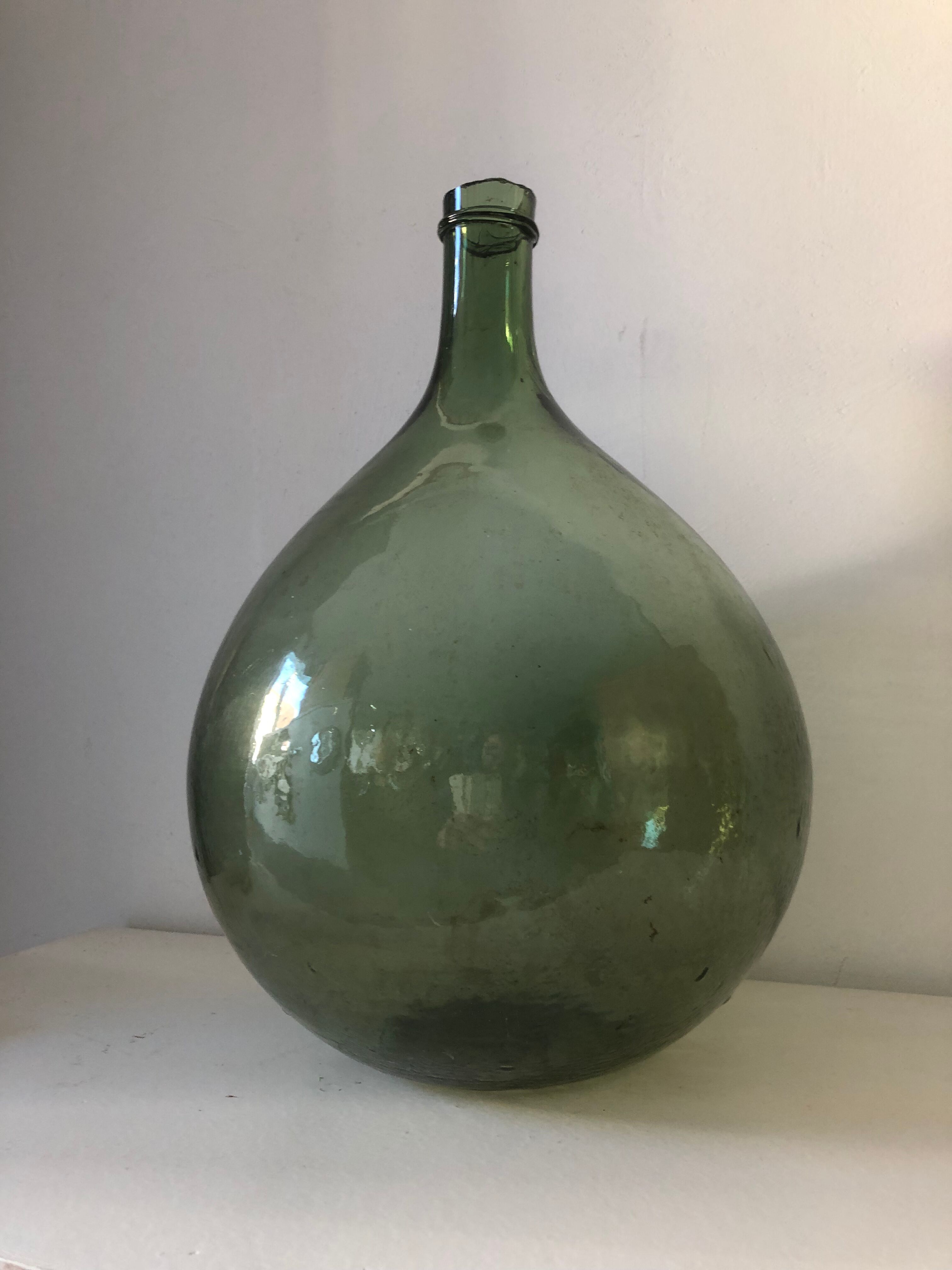 Demijohn old bottle in blown glass
