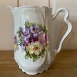 Old ceramic pitcher decorated with flowers