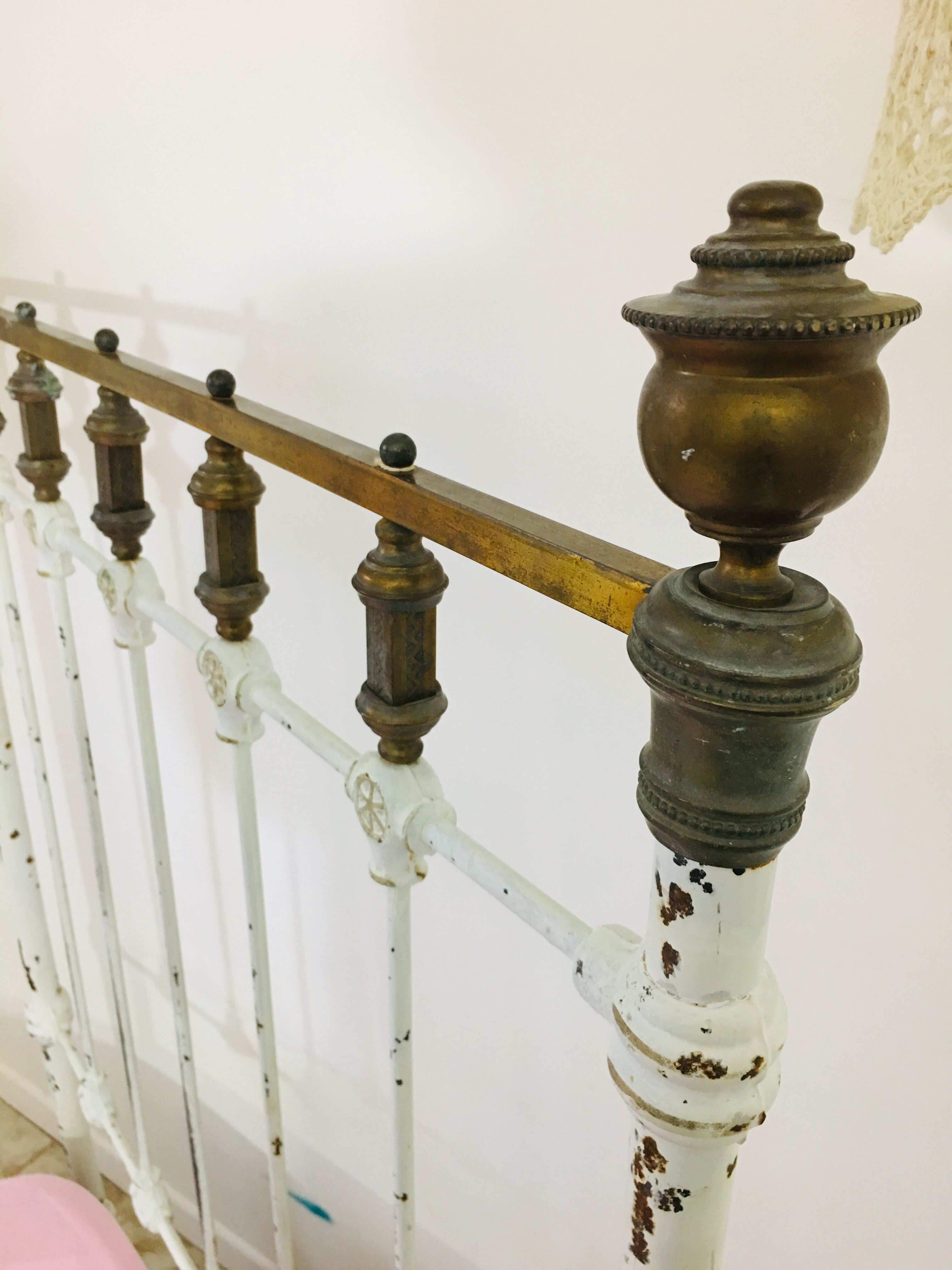 Old white metal and brass bed