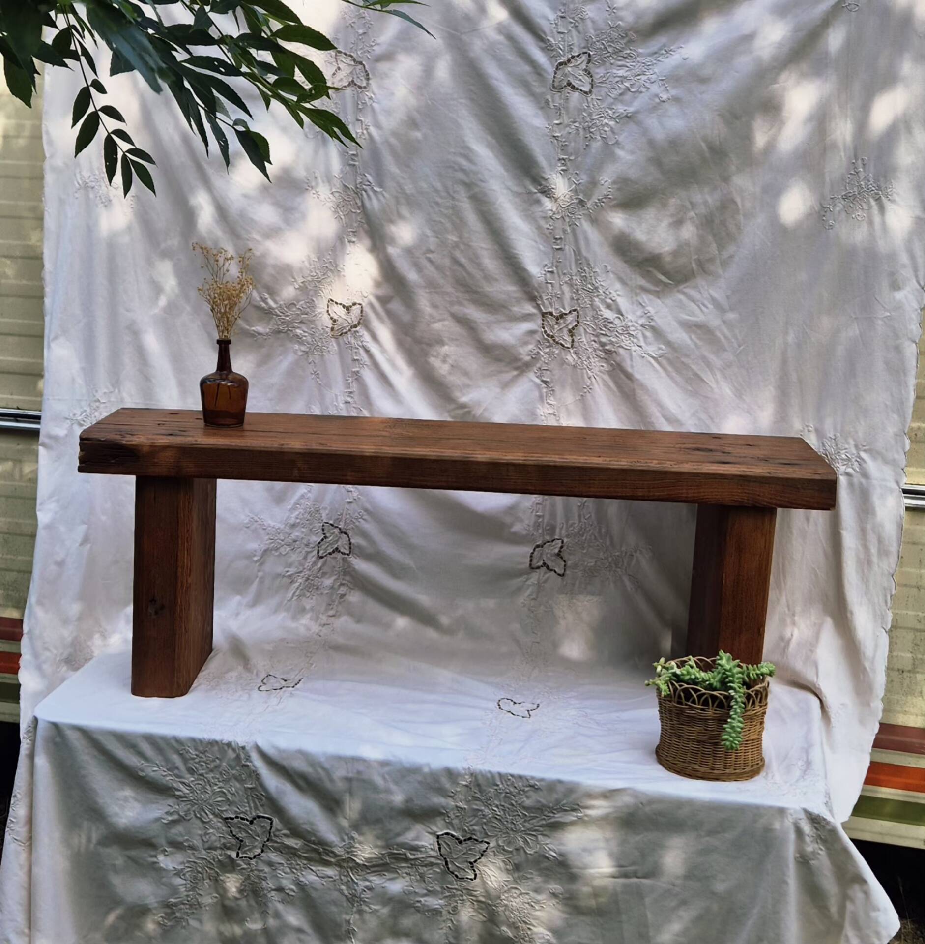 Brutalist wooden bench made of solid oak beam.