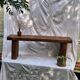 Brutalist wooden bench made of solid oak beam.