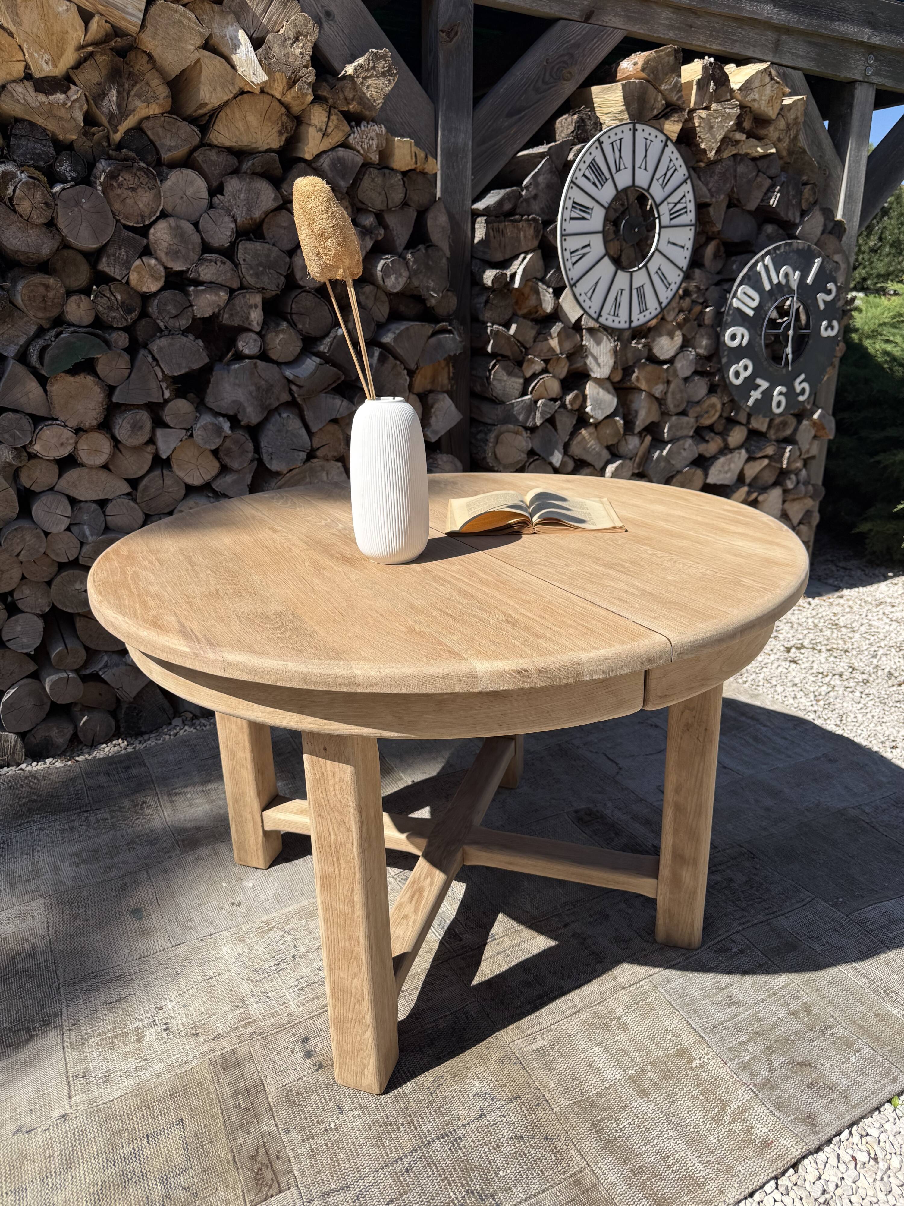 Round solid oak table with extensions, maximum 220cm.