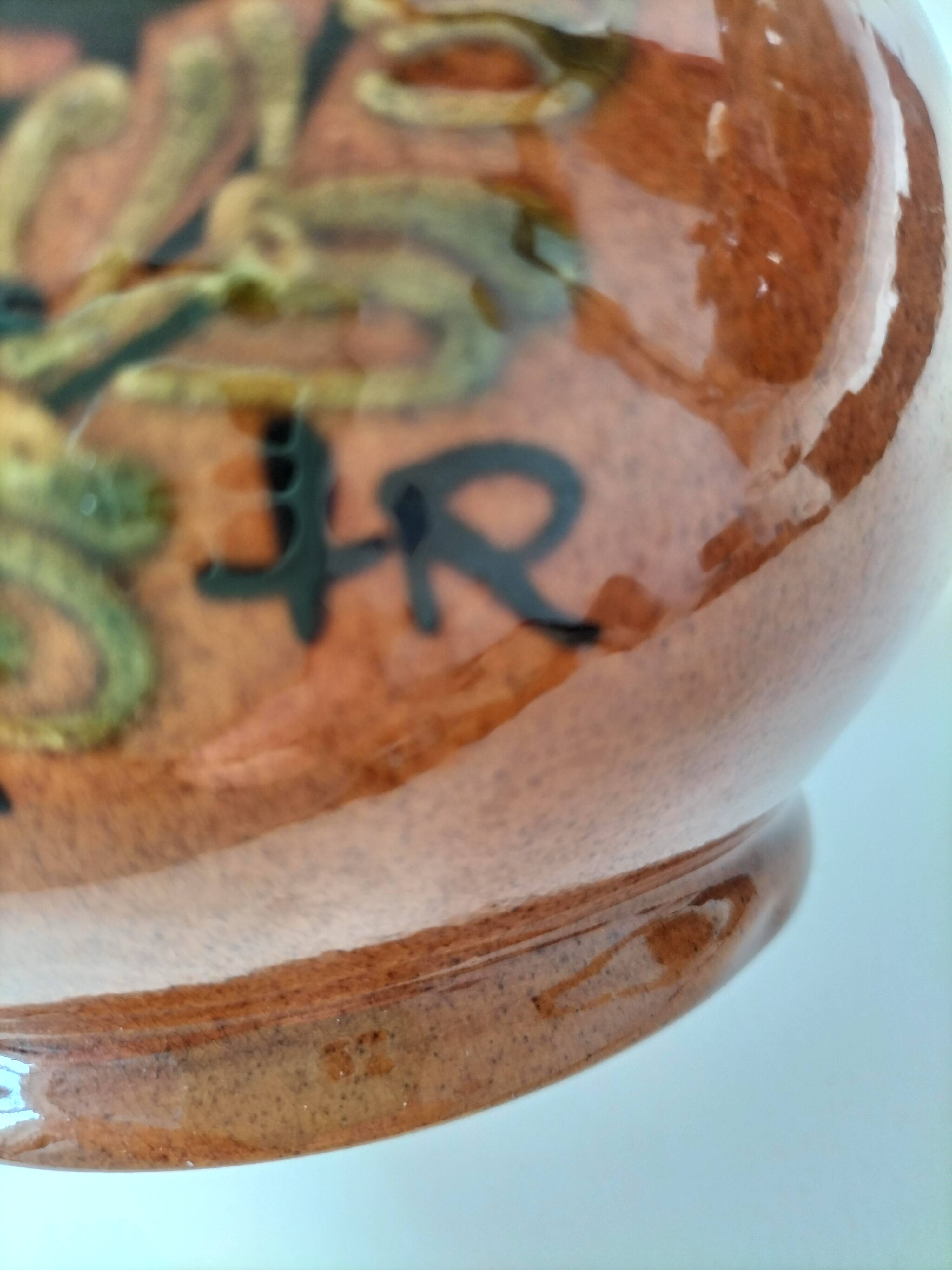 Glazed earthenware pitcher signed HR with a design of stylised birds.