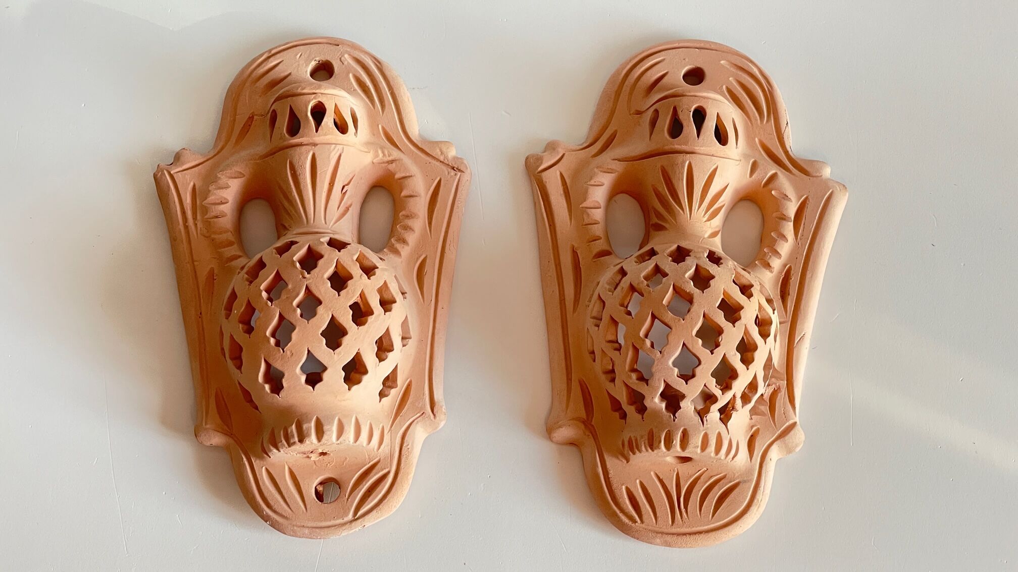 Pair of terracotta wall candle holders