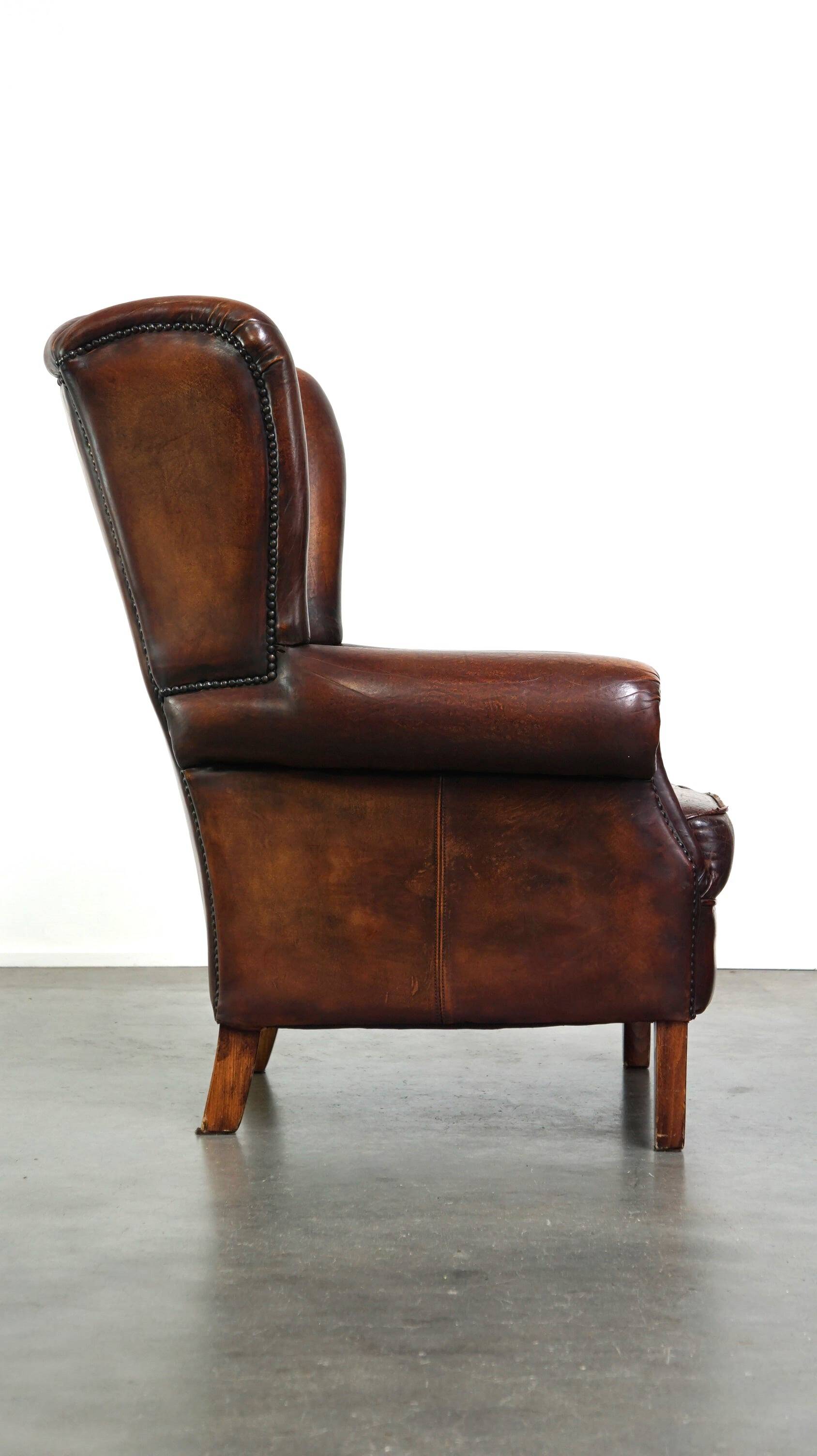 Luxurious sheepskin armchair with a fixed seat cushion and high seating comfort