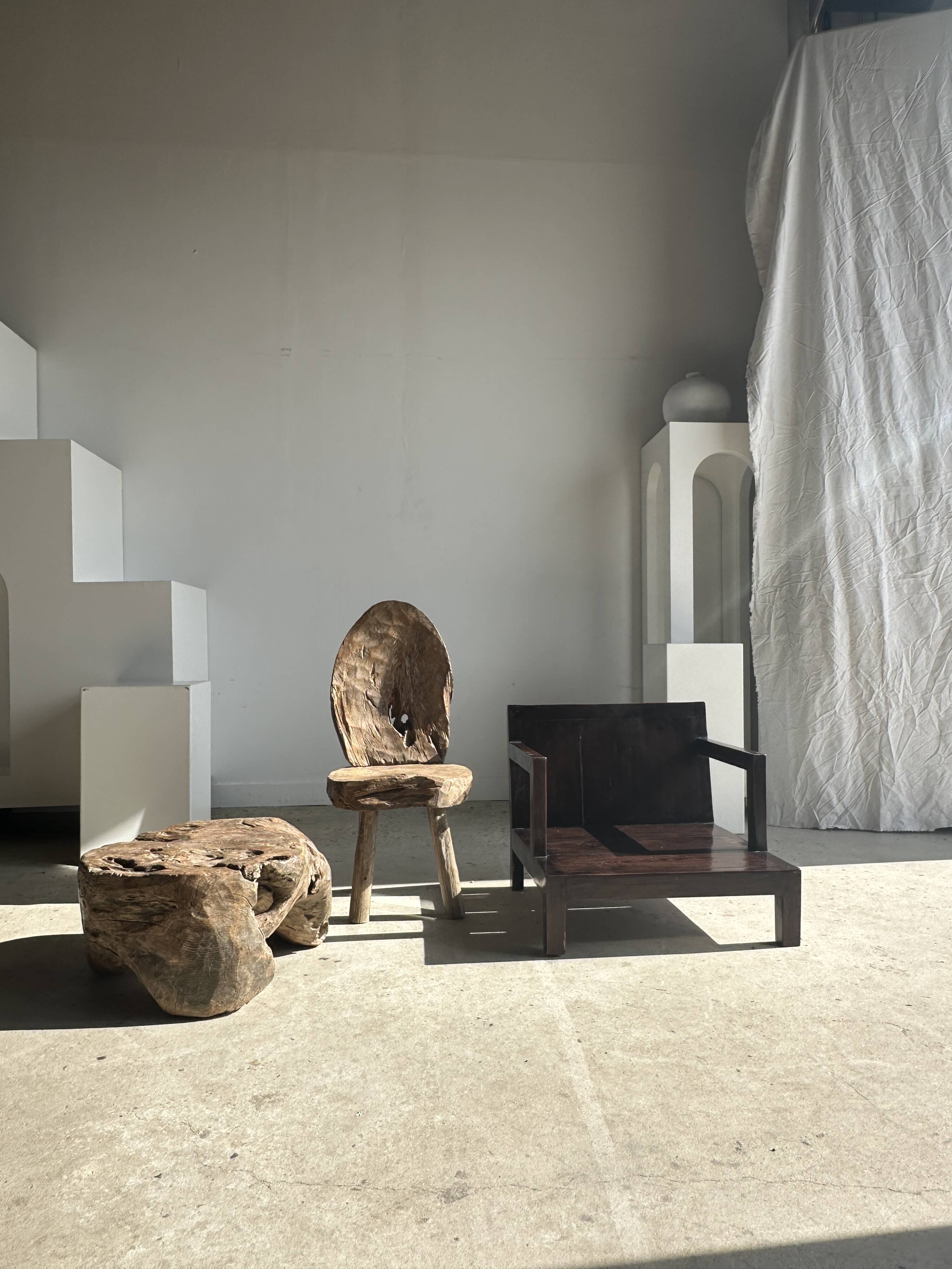 Small low armchair in varnished brown wood