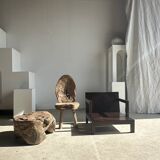 Small low armchair in varnished brown wood