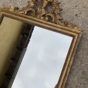 Antique mirror in wood and gilded stucco with a pediment - in the style of the 18th century.
