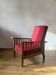 Morris chair with wooden frame and burgundy cushions.
