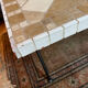 Beige ceramic coffee table with black metal legs.